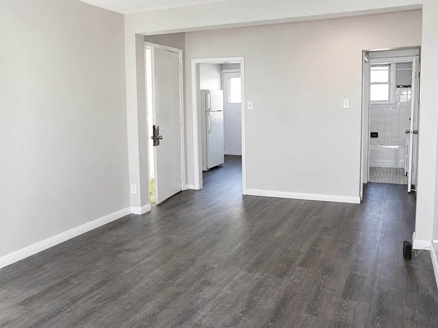 Clarence Apartments — living room opening to kitchen