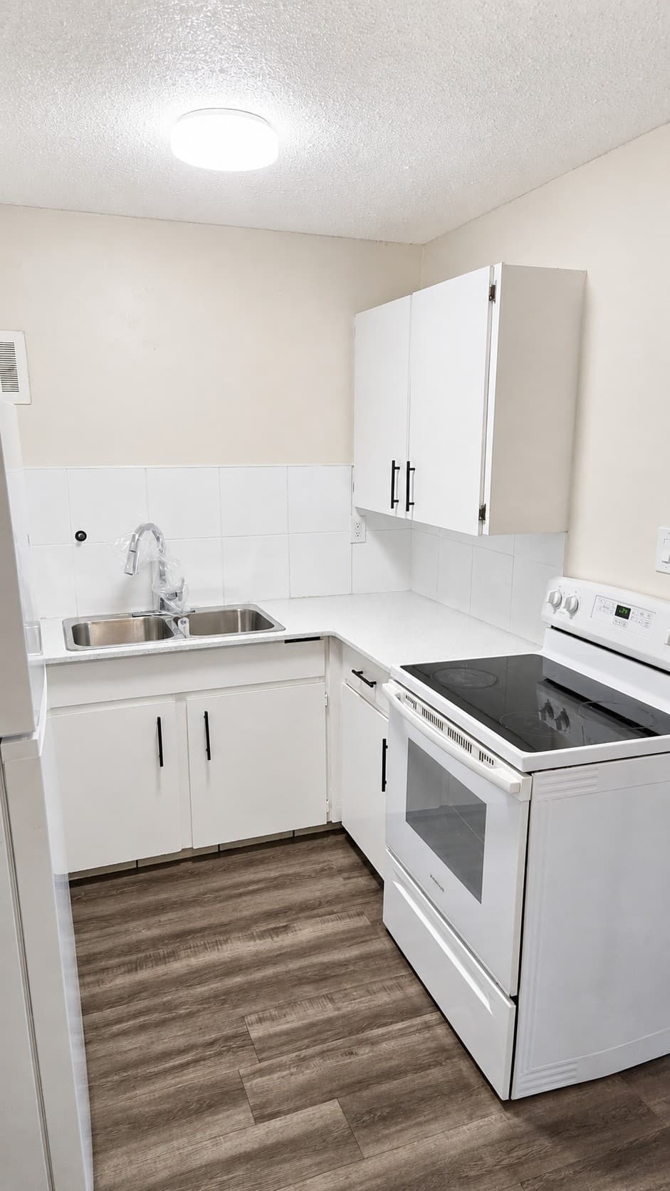 Dakota Apartments — kitchen with white cabinets