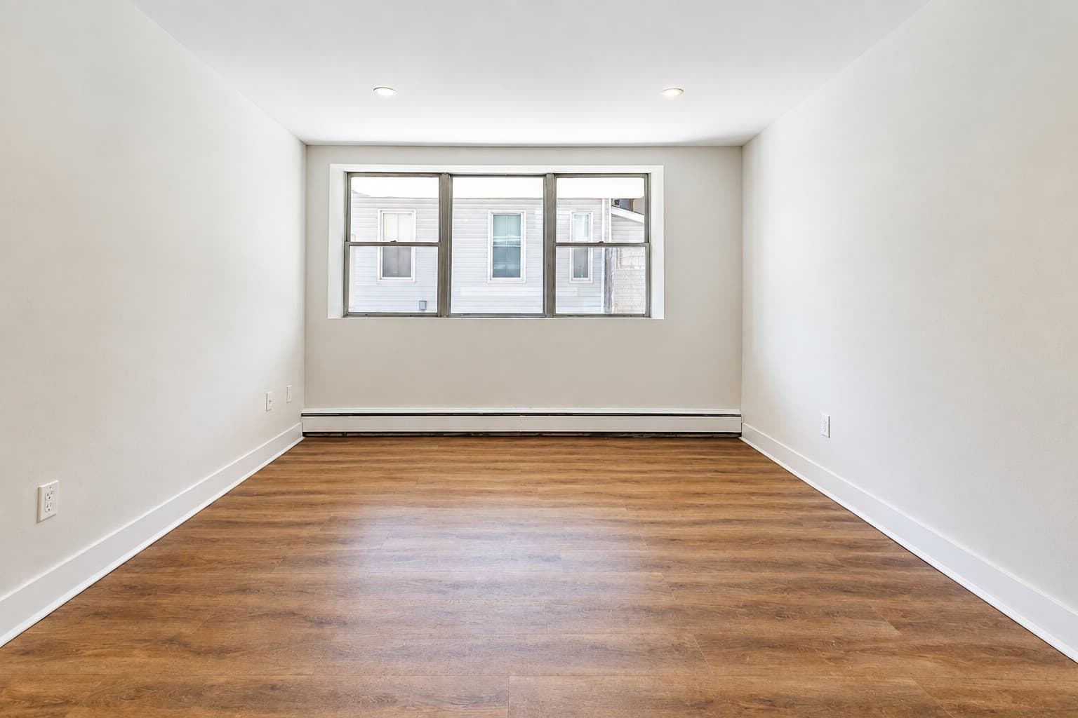 High Apartments — bright open room with large window