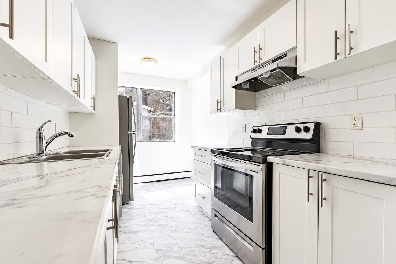 High Apartments — renovated white kitchen with marble-look counters