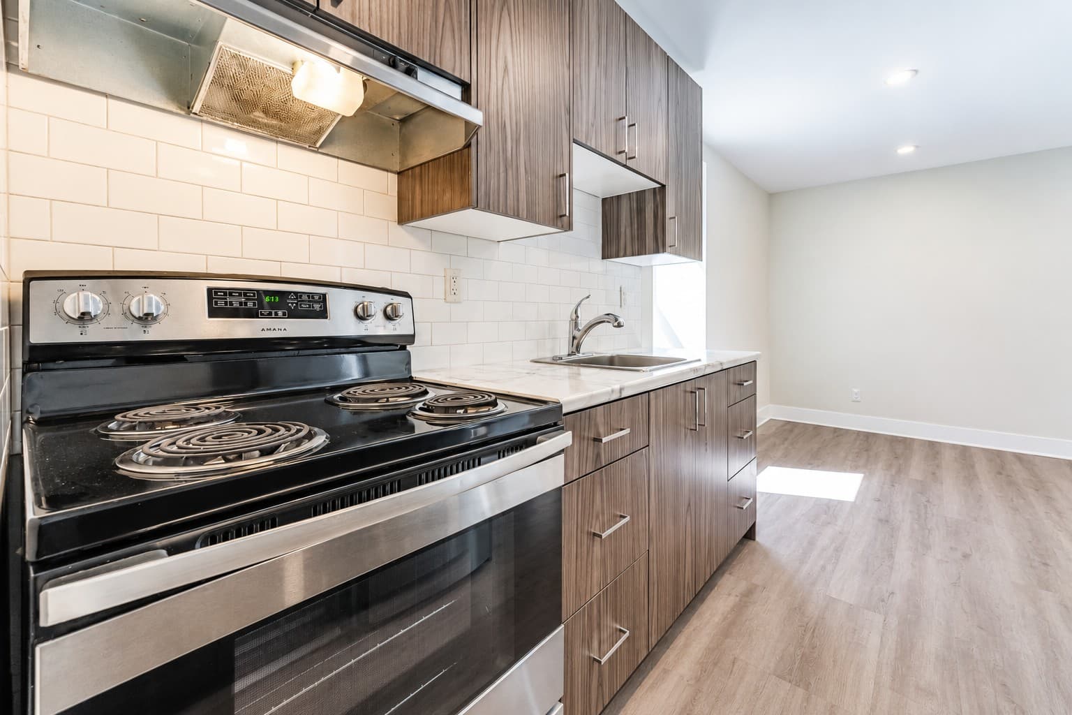 High Apartments — kitchen with wood-grain cabinets