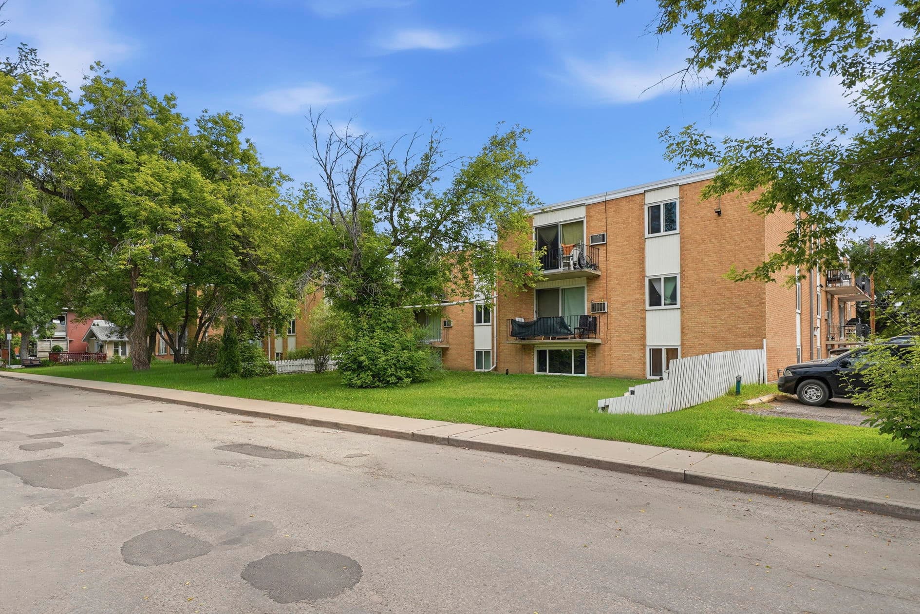 Midtown Apartments — exterior with lawn and balconies