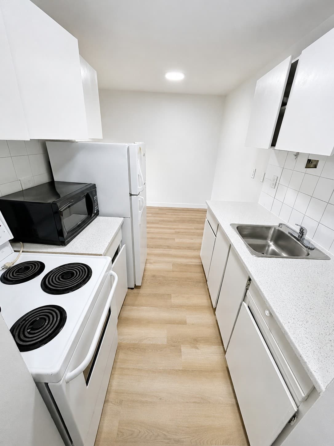 Westlynn Apartments — kitchen with white cabinets